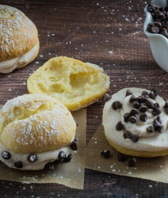 These cream puffs are sweet, tender, stuffed with an irresistible cannoli cream filling and topped with just a sprinkle of powdered sugar. Enjoy this traditional French pastry with an Italian twist, or fill it with whatever sweet treat you're craving. You won't believe how deceptively easy they are to make, and your guests won't be able to tell they're gluten free!