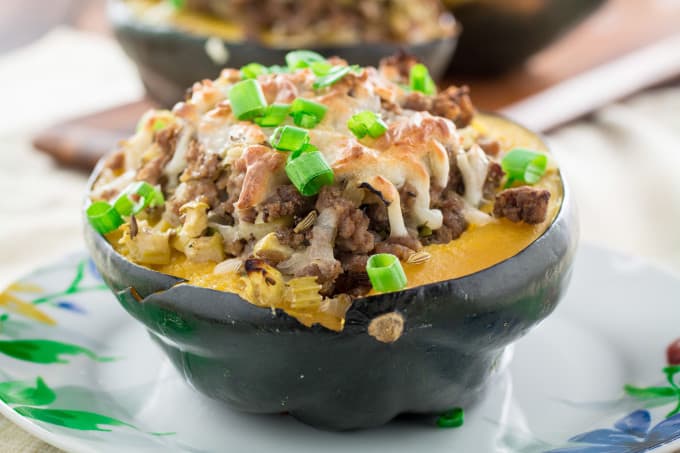 Sweet, nutty acorn squash stuffed with a savory homemade turkey sausage, onions and gooey mozzarella cheese and baked to perfection. You won't believe how simply easy these are to make, and they look so fancy! Serve this satisfying Acorn Squash Stuffed with Turkey Sausage as a side dish during the holidays or as the main course!