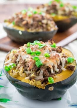 Sweet, nutty acorn squash stuffed with a savory homemade turkey sausage, onions and gooey mozzarella cheese and baked to perfection. You won't believe how simply easy these are to make, and they look so fancy! Serve this satisfying Acorn Squash Stuffed with Turkey Sausage as a side dish during the holidays or as the main course!