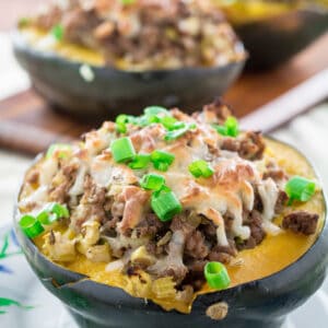 Sweet, nutty acorn squash stuffed with a savory homemade turkey sausage, onions and gooey mozzarella cheese and baked to perfection. You won't believe how simply easy these are to make, and they look so fancy! Serve this satisfying Acorn Squash Stuffed with Turkey Sausage as a side dish during the holidays or as the main course!