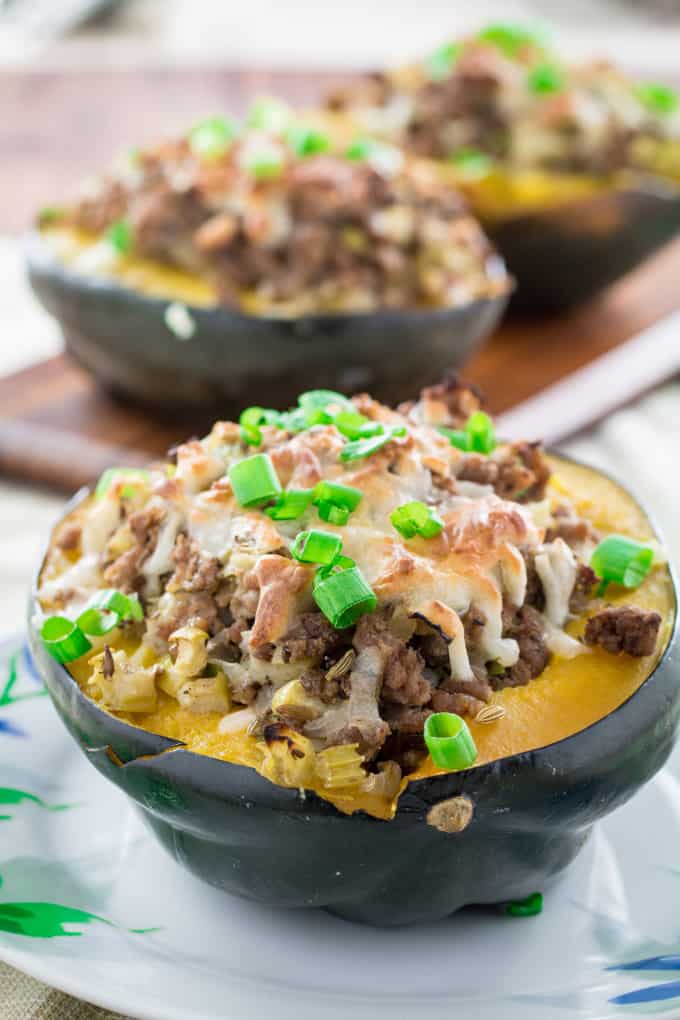 Sweet, nutty acorn squash stuffed with a savory homemade turkey sausage, onions and gooey mozzarella cheese and baked to perfection. You won't believe how simply easy these are to make, and they look so fancy! Serve this satisfying Acorn Squash Stuffed with Turkey Sausage as a side dish during the holidays or as the main course!