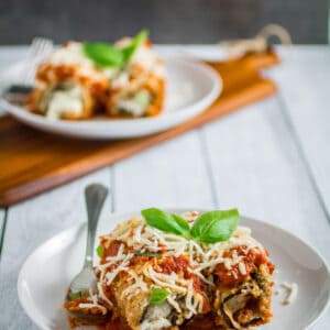 Savory oven-fried eggplant stuffed with an herby parmesan and ricotta cheese filling, smothered with marinara sauce and baked to perfection. This Easy Eggplant Rollantini is the perfect meal for when you just have to enjoy a hearty Italian dinner. A perfect match for your favorite bottle of vino, you won't believe how easy this dish is to make!
