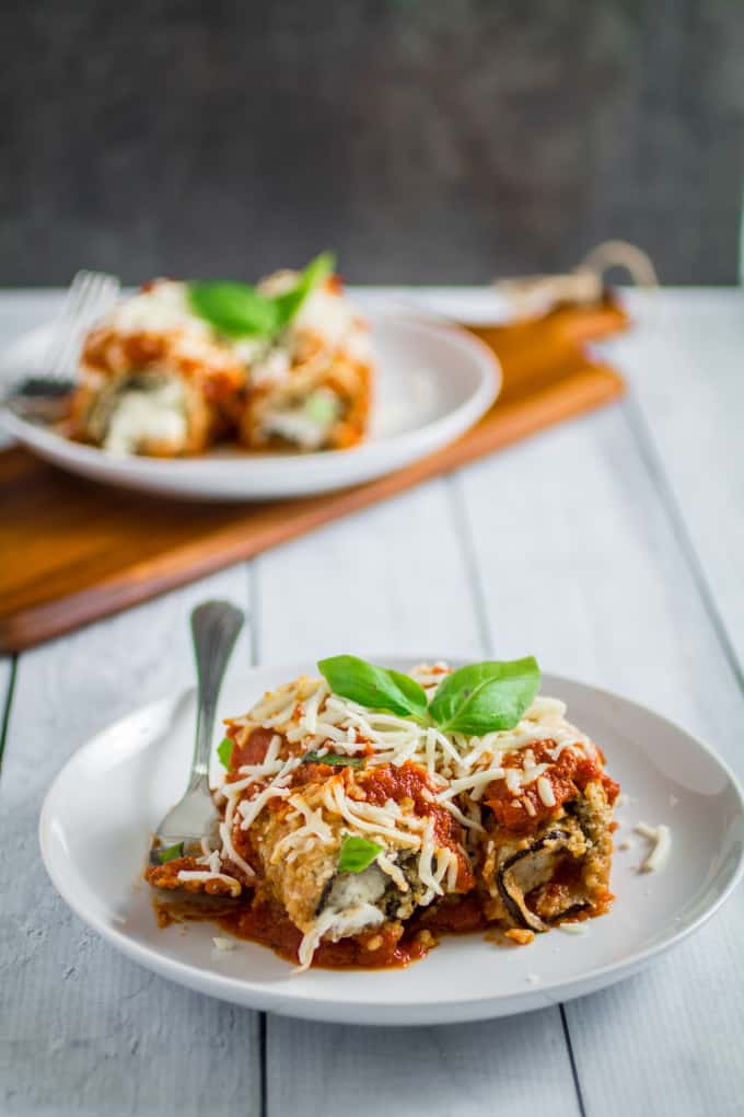 Savory oven-fried eggplant stuffed with an herby parmesan and ricotta cheese filling, smothered with marinara sauce and baked to perfection. This Easy Eggplant Rollatini is the perfect meal for when you just have to enjoy a hearty Italian dinner. A perfect match for your favorite bottle of vino, you won't believe how easy this dish is to make!