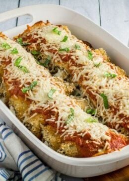 Savory oven-fried eggplant stuffed with an herby parmesan and ricotta cheese filling, smothered with marinara sauce and baked to perfection. This Easy Eggplant Rollantini is the perfect meal for when you just have to enjoy a hearty Italian dinner. A perfect match for your favorite bottle of vino, you won't believe how easy this dish is to make!