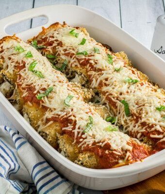 Savory oven-fried eggplant stuffed with an herby parmesan and ricotta cheese filling, smothered with marinara sauce and baked to perfection. This Easy Eggplant Rollantini is the perfect meal for when you just have to enjoy a hearty Italian dinner. A perfect match for your favorite bottle of vino, you won't believe how easy this dish is to make!