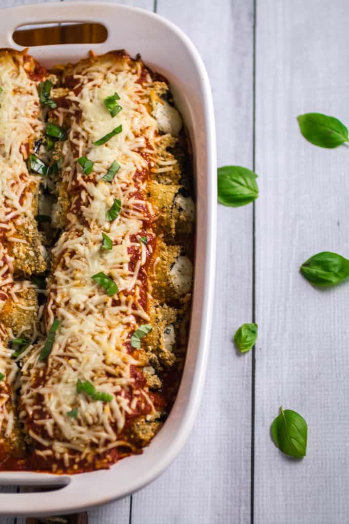 Savory oven-fried eggplant stuffed with an herby parmesan and ricotta cheese filling, smothered with marinara sauce and baked to perfection. This Easy Eggplant Rollatini is the perfect meal for when you just have to enjoy a hearty Italian dinner. A perfect match for your favorite bottle of vino, you won't believe how easy this dish is to make!