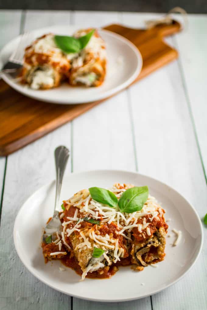 Savory oven-fried eggplant stuffed with an herby parmesan and ricotta cheese filling, smothered with marinara sauce and baked to perfection. This Easy Eggplant Rollatini is the perfect meal for when you just have to enjoy a hearty Italian dinner. A perfect match for your favorite bottle of vino, you won't believe how easy this dish is to make!