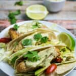 Crispy, juicy oven-fried fish smothered in a creamy, spicy avocado sauce and nestled in a warm tortilla. These Oven Fried Fish Tacos with Spicy Avocado Cream Sauce are simply perfect. Top with crunchy cabbage, cilantro, and a squeeze of fresh lime for an incredible flavor in this insanely easy-to-make dish!