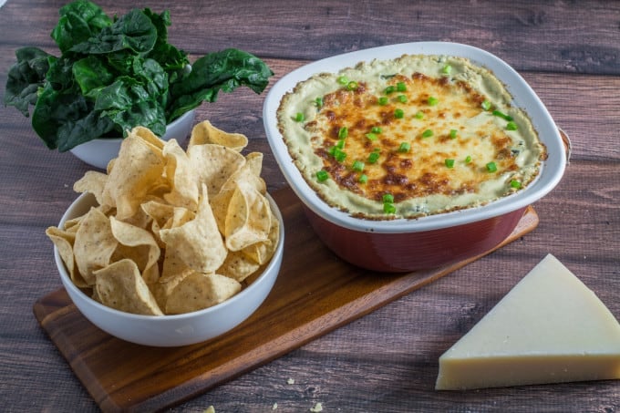 Cheesy, rich, and comfortingly creamy, it doesn't get much better than this classic Spinach Artichoke Dip. Topped with mozzarella cheese and baked to perfection, this dip recipe can be served with tortilla chips or a toasted baguette. You may want to make extra, this is one flavorful party food that won't last long once it's on the table!