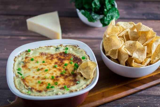 Cheesy, rich, and comfortingly creamy, it doesn't get much better than this classic Spinach Artichoke Dip. Topped with mozzarella cheese and baked to perfection, this dip recipe can be served with tortilla chips or a toasted baguette. You may want to make extra, this is one flavorful party food that won't last long once it's on the table! 