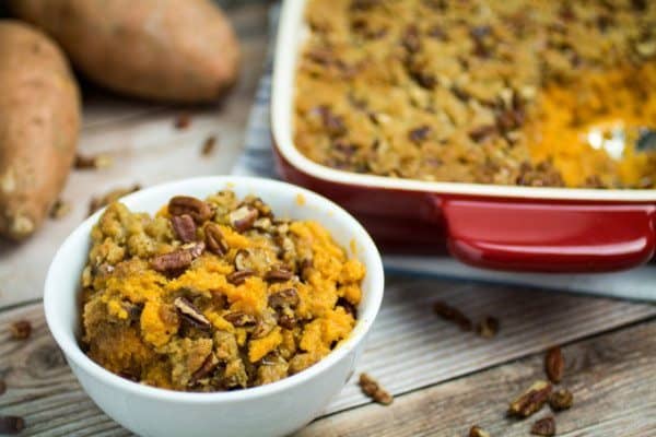 This traditional Thanksgiving casserole recipe uses baked sweet potatoes mashed together with brown sugar and autumn spices, then topped with a sweet and crunchy layer of crumble and pecans. A touch of maple syrup brings the rich, buttery taste of this Easy Sweet Potato Casserole with Pecan Crumble Topping to the next level! This really is the perfect side dish for your holiday table.