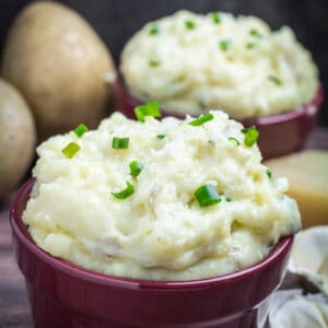Creamy, buttery Yukon gold potatoes are mashed together with garlic and sharp Parmesan cheese in these Creamy Garlic Parmesan Mashed Potatoes. These potatoes are perfect for your Thanksgiving table, but so easy that you'll want to make them all year round. Top with chives and serve with an extra sprinkle of Parmesan cheese and butter for the perfect holiday side dish.