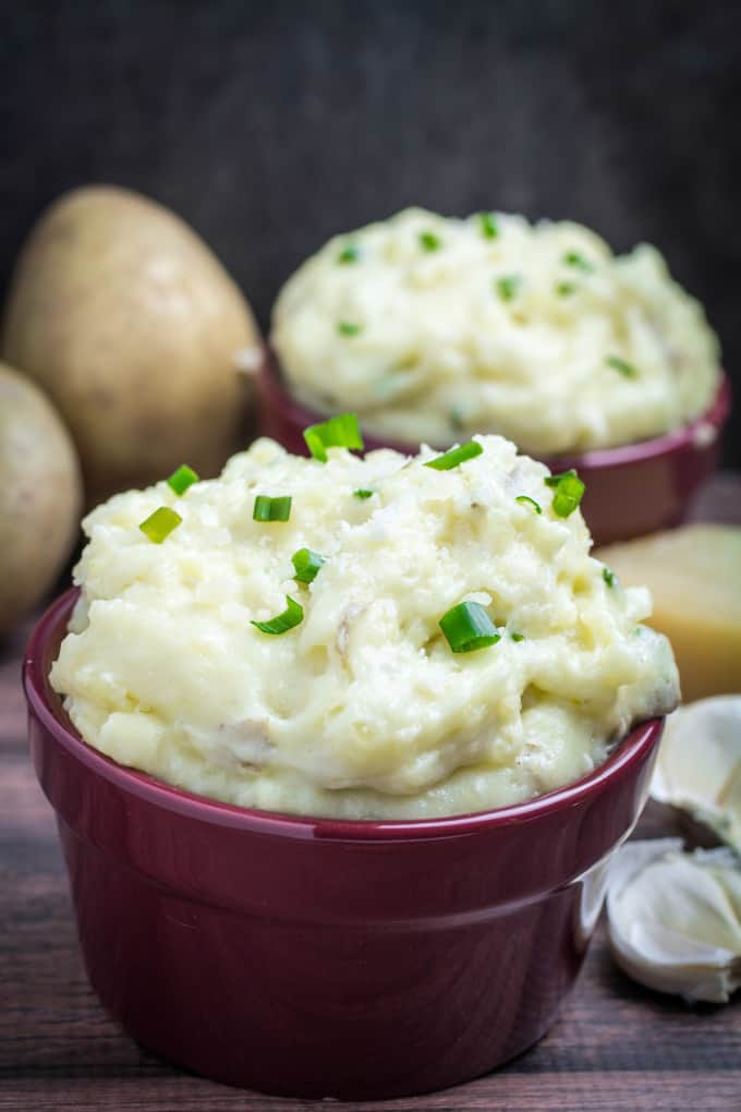 Creamy, buttery Yukon gold potatoes are mashed together with garlic and sharp Parmesan cheese in these Creamy Garlic Parmesan Mashed Potatoes. These potatoes are perfect for your Thanksgiving table, but so easy that you'll want to make them all year round. Top with chives and serve with an extra sprinkle of Parmesan cheese and butter for the perfect holiday side dish.