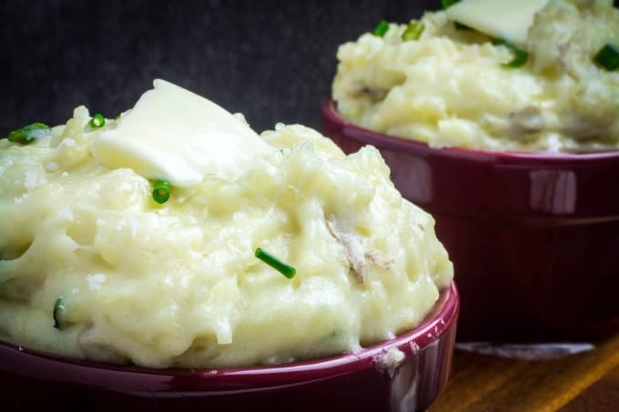 Creamy, buttery Yukon gold potatoes are mashed together with garlic and sharp Parmesan cheese in these Creamy Garlic Parmesan Mashed Potatoes. These potatoes are perfect for your Thanksgiving table, but so easy that you'll want to make them all year round. Top with chives and serve with an extra sprinkle of Parmesan cheese and butter for the perfect holiday side dish.