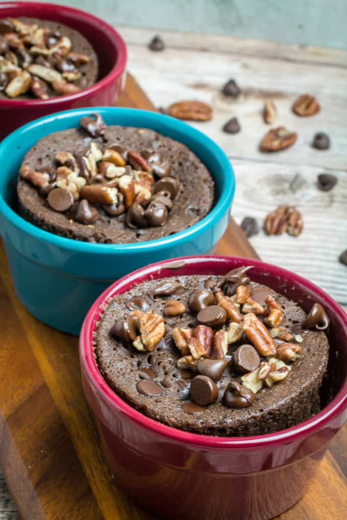 Rich chocolate cake made in less than 2 minutes! This Gluten Free Chocolate Mug Cake is bursting with smooth chocolate chips and crunchy pecans. So easy to make, this chocolate mug cake is made in your favorite coffee mug or small baking dish, and only takes a minute and a half in the microwave before it's finished. Gluten free baking has never been easier!