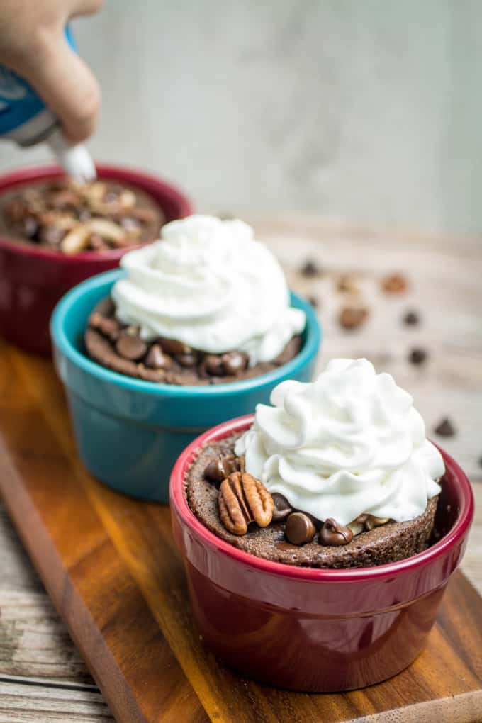 Rich chocolate cake made in less than 2 minutes! This Gluten Free Chocolate Mug Cake is bursting with smooth chocolate chips and crunchy pecans. So easy to make, this chocolate mug cake is made in your favorite coffee mug or small baking dish, and only takes a minute and a half in the microwave before it's finished. Gluten free baking has never been easier!