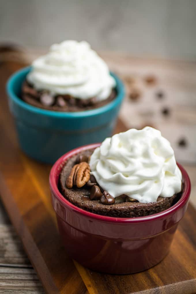 Rich chocolate cake made in less than 2 minutes! This Gluten Free Chocolate Mug Cake is bursting with smooth chocolate chips and crunchy pecans. So easy to make, this chocolate mug cake is made in your favorite coffee mug or small baking dish, and only takes a minute and a half in the microwave before it's finished. Gluten free baking has never been easier!