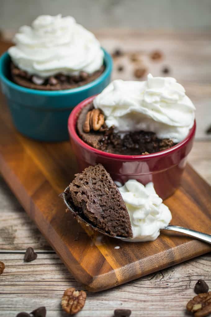 Rich chocolate cake made in less than 2 minutes! This Gluten Free Chocolate Mug Cake is bursting with smooth chocolate chips and crunchy pecans. So easy to make, this chocolate mug cake is made in your favorite coffee mug or small baking dish, and only takes a minute and a half in the microwave before it's finished. Gluten free baking has never been easier!