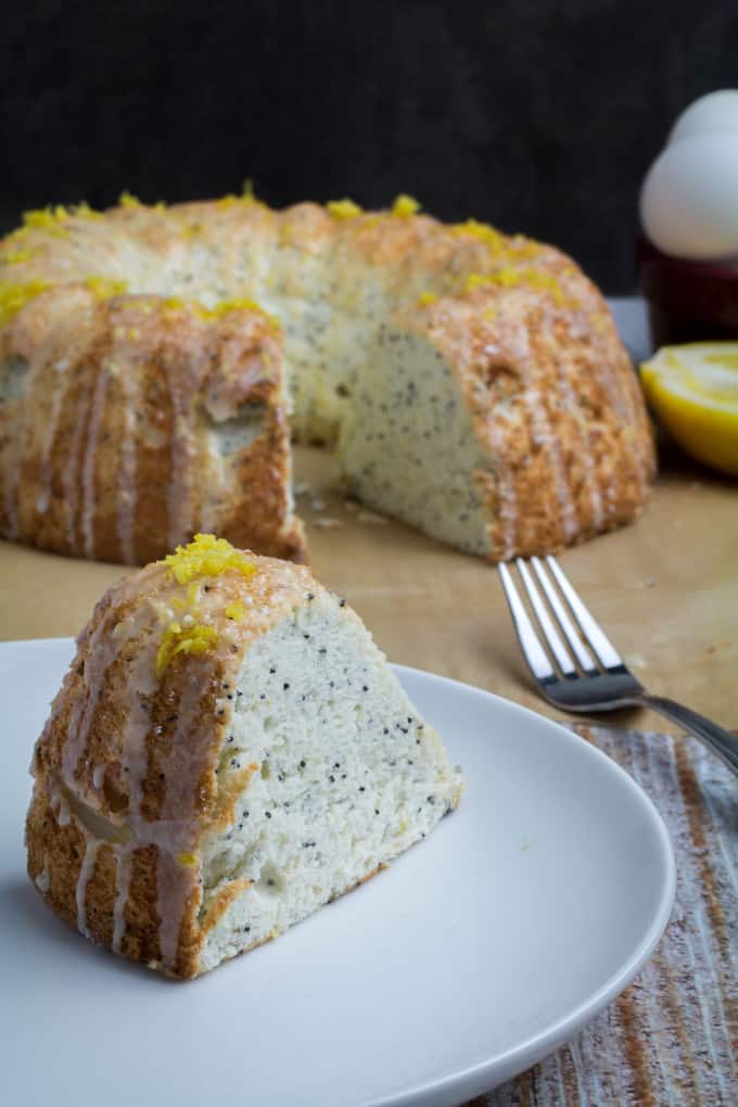 Sweet and sour come together in a perfect pairing with this Gluten Free Lemon Poppy Seed Angel Food Cake. Light and fluffy angel food cake is mixed with the tart flavor of lemon, nutty poppy seeds, and drizzled with a sweet lemon-sugar icing that takes this twist on the classic angel food cake over the top. You'll never even know it's gluten free!