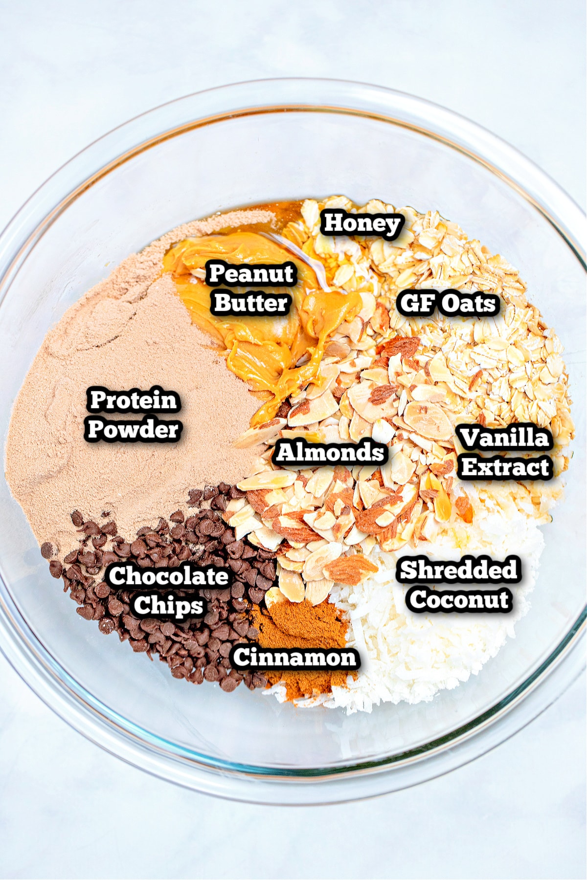 Individual ingredients for peanut butter protein balls in a bowl on the table.