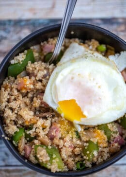 country quinoa bowl closeup with over easy egg on top