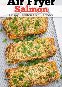 Pinterest pin for air fryer salmon with salmon sitting on an air fryer shelf with crispy breadcrumb topping.