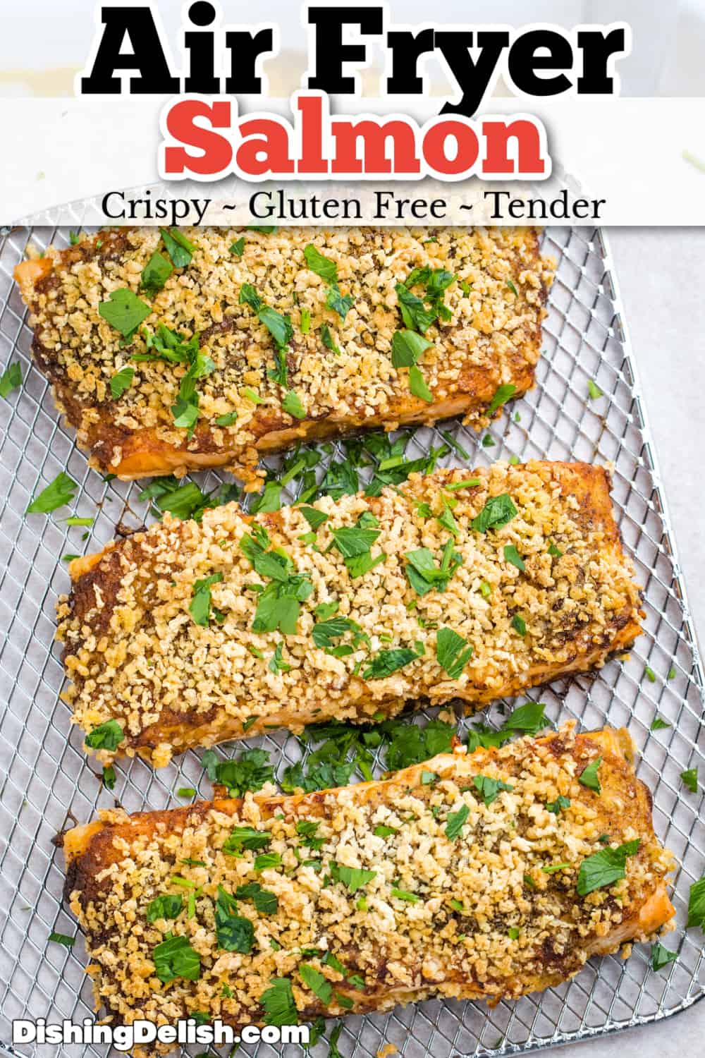 Pinterest pin for air fryer salmon with salmon sitting on an air fryer shelf with crispy breadcrumb topping.