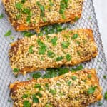 Close up of air fryer salmon with breadcrumb topping on an air fryer shelf.