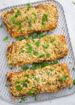 Close up of air fryer salmon with breadcrumb topping on an air fryer shelf.