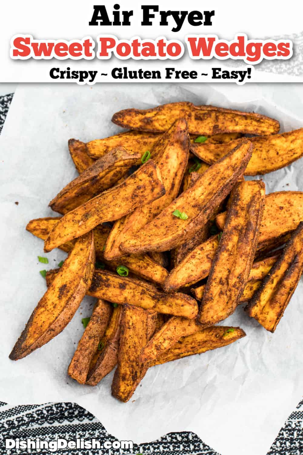Air fryer sweet potato wedges on top of parchment paper.