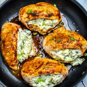 Finished broccoli and cheese stuffed chicken breasts in a nonstick skillet.