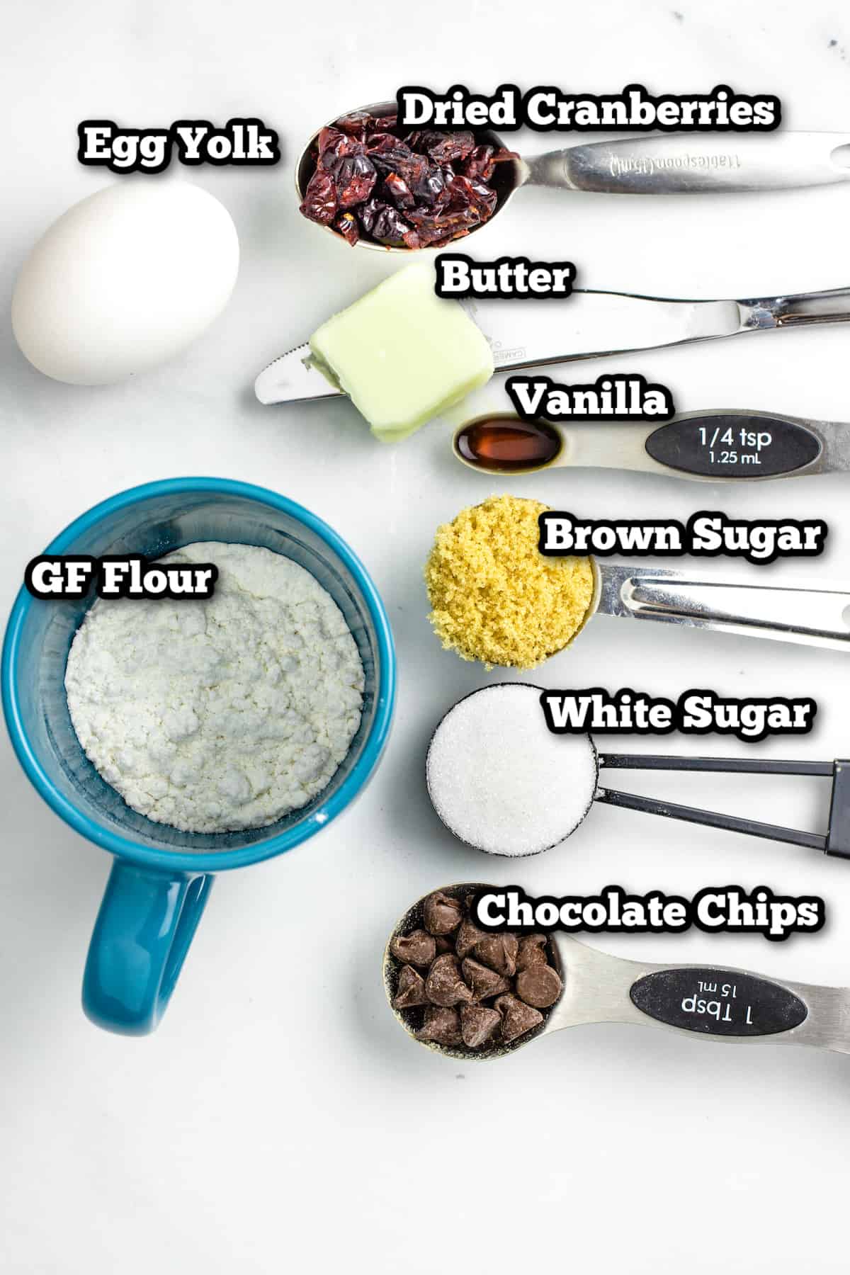 Individual ingredients for chocolate chip mug cookie on a table.