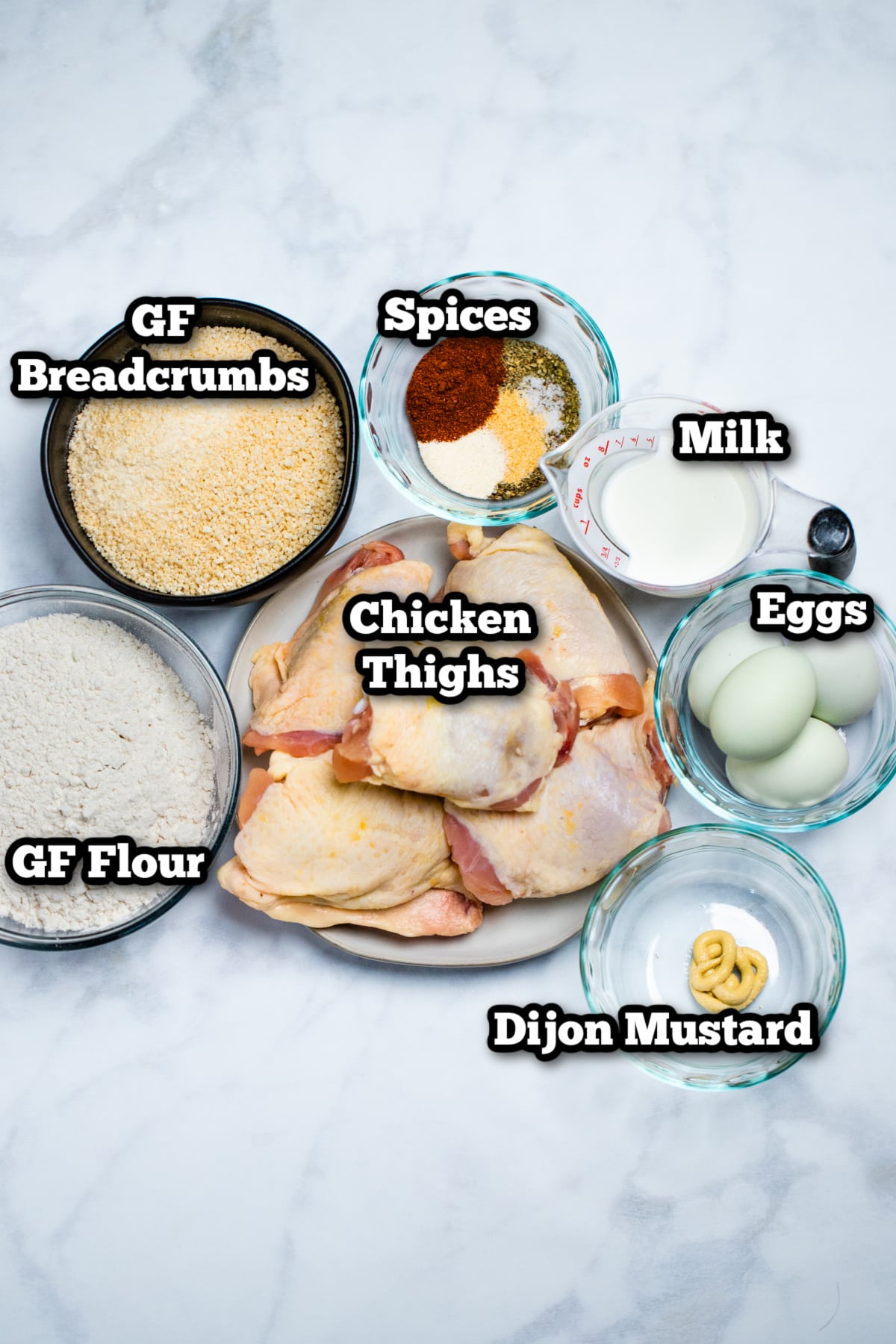 Individual ingredients needed to make oven fried chicken thighs on a table.