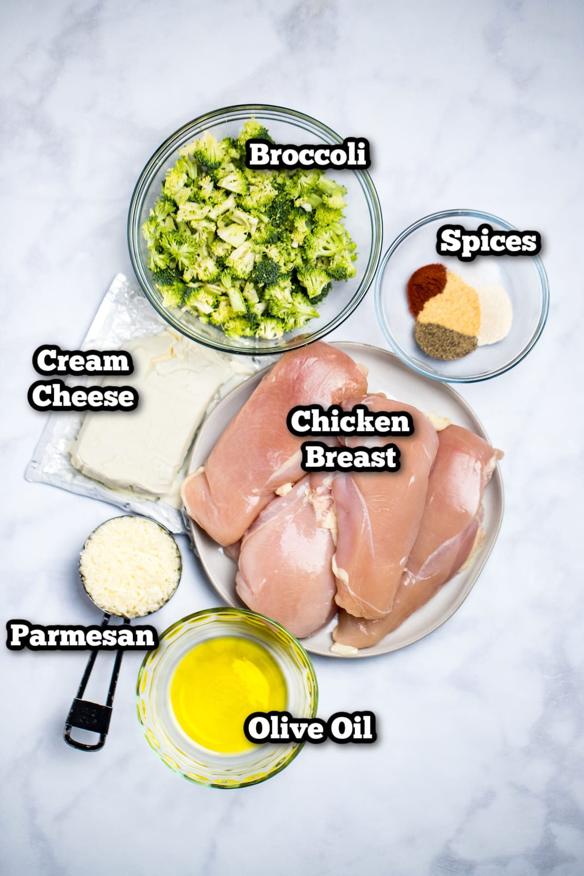 Individual ingredients needed to make broccoli and cheese stuffed chicken on a table.