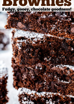 Pinterest pin with a photo of four brownies stacked on top of each other dusted in powdered sugar.
