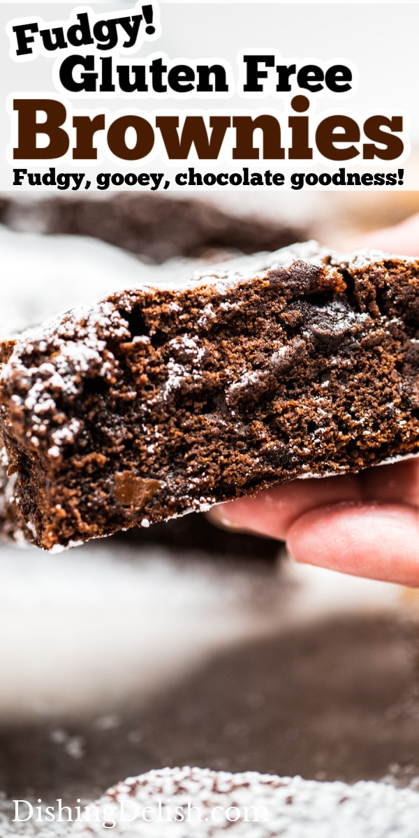 Pinterest pin with a photo of a hand holding a brownie with the chocolate fudgy side showing.