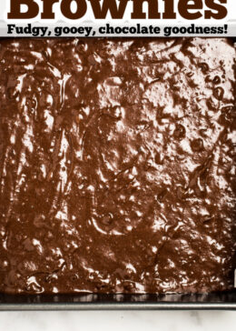 Pinterest pin with a photo of raw brownie batter in a pan ready to be baked.