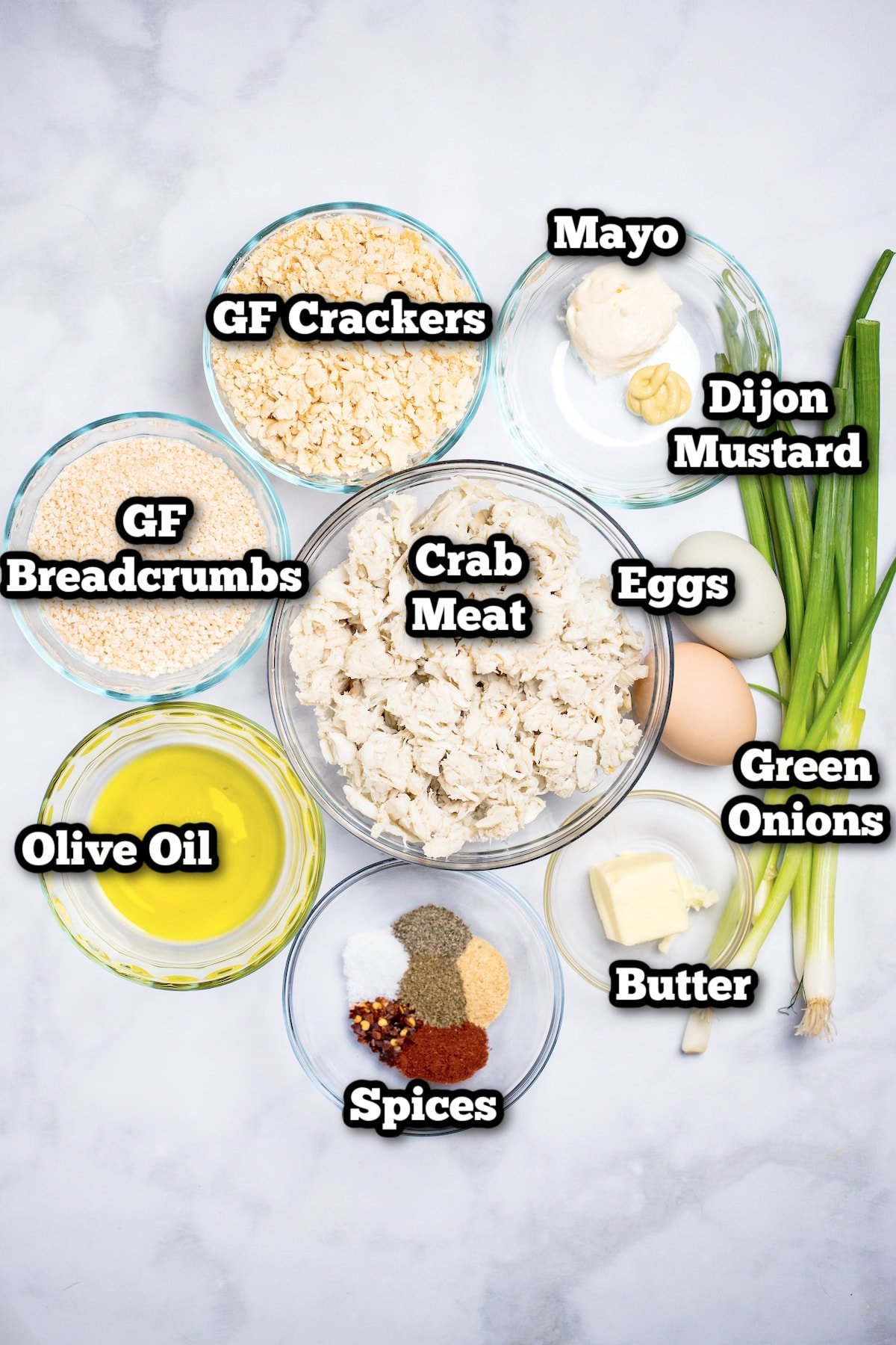 Ingredients needed to make gluten free crab cakes on a marble table.