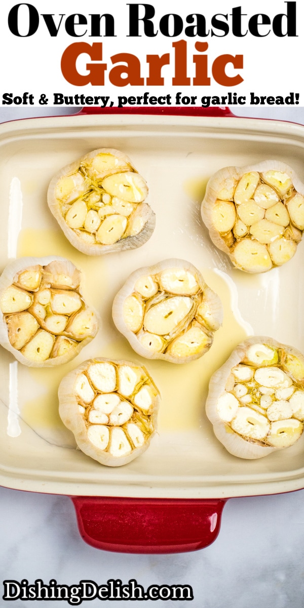 Raw garlic bulbs topped with olive oil sitting in a baking dish.