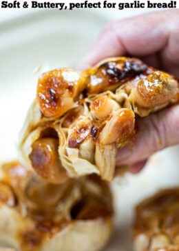 Pinterest pin with a hand holding a roasted garlic bulb.