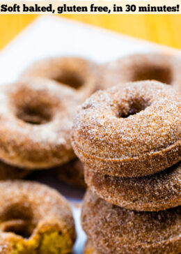 Pinterest pin with four doughnuts coated in cinnamon sugar stacked on top of each other.