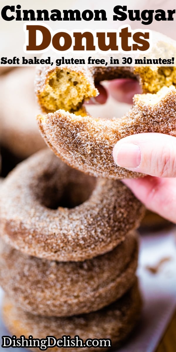 Pinterest pin with four doughnuts coated in cinnamon sugar stacked on top of each other and two hands holding the top doughnut.
