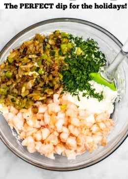 Pinterest pin with ingredients for shrimp dip in a bowl with a spatula.