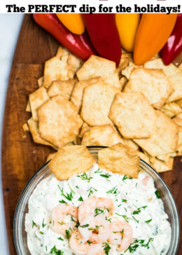 Pinterest pin of a bowl of shrimp dip with mini shrimp on top next to gluten free crackers and peppers.