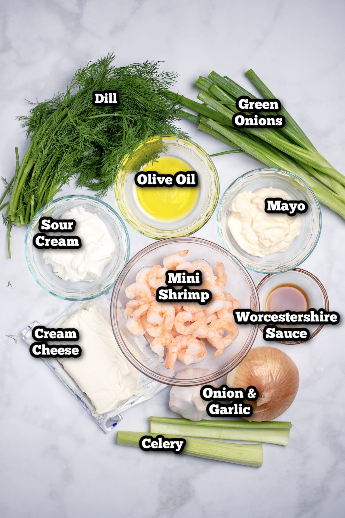 Ingredients for cream cheese shrimp dip on a marble table.