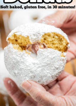 Pinterest pin with two hands breaking a powdered sugar donut in half.