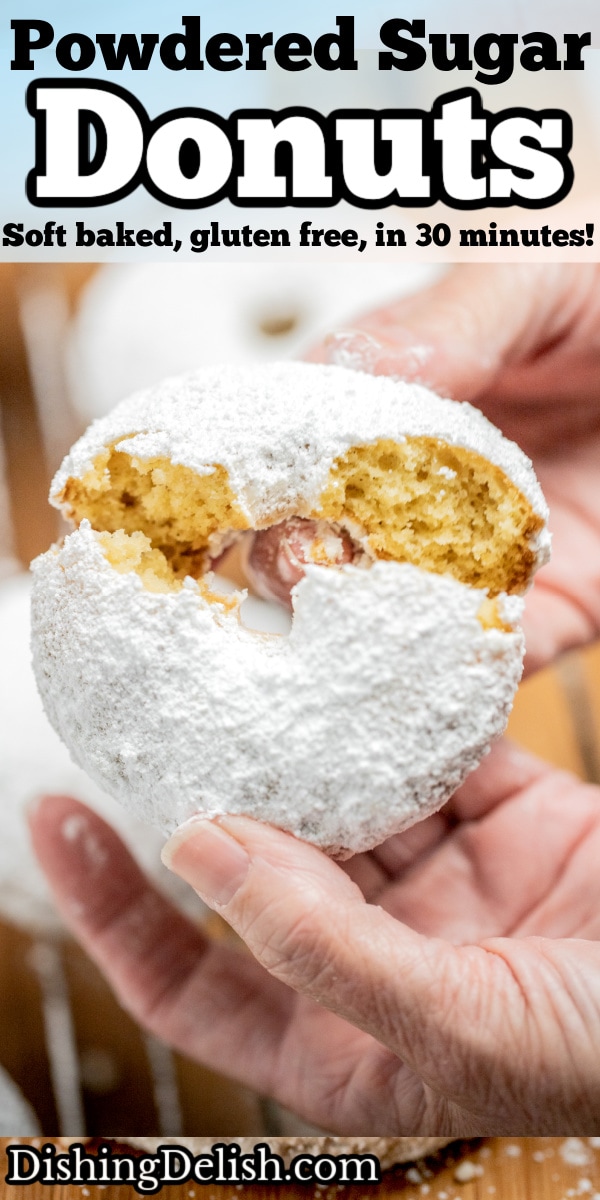 Pinterest pin with two hands breaking a powdered sugar donut in half.