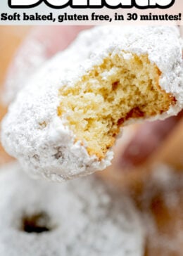 Pinterest pin with a hand holding a powdered sugar donut with a bite taken out of it.