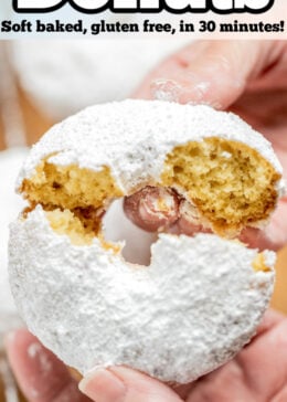 Pinterest pin with two hands breaking a powdered sugar donut in half.