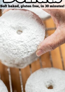 Pinterest pin with a hand holding a powdered sugar donut.